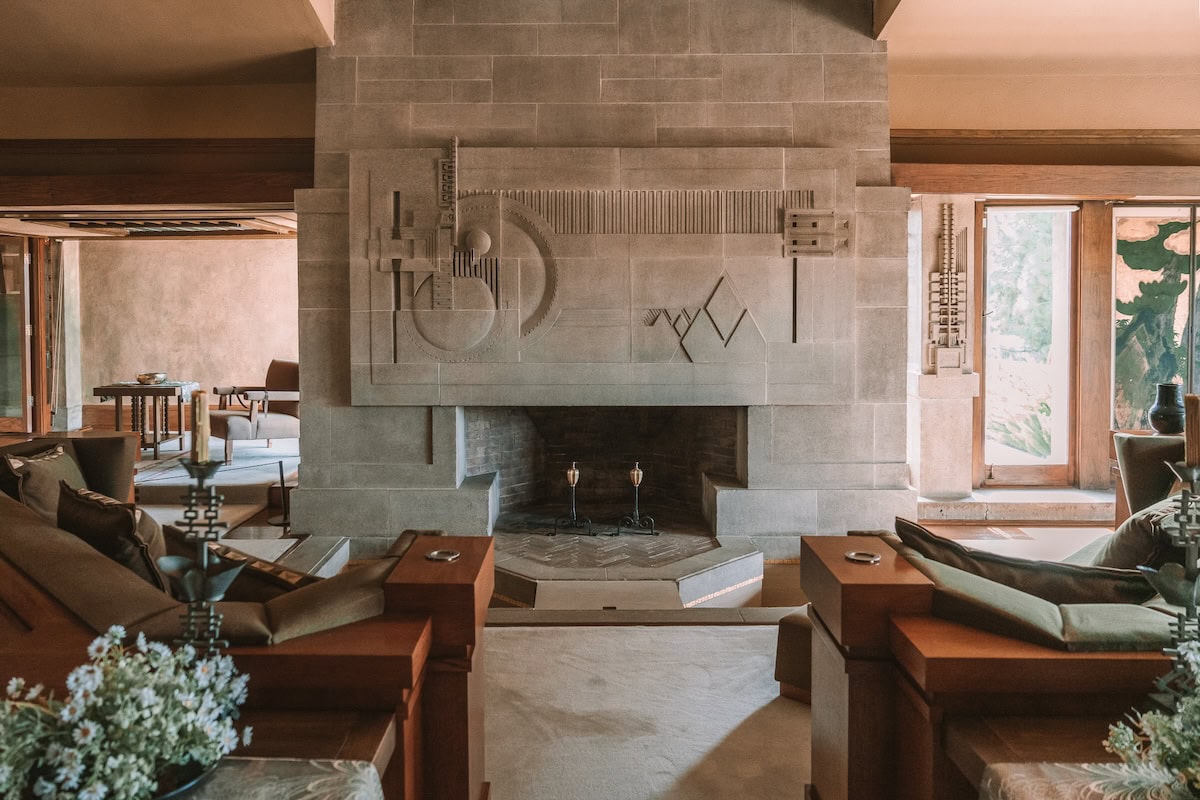 Hollyhock House in Los Angeles Interior fireplace made of gray stone and decorated with unique carvings inside the Hollyhock House in Los Angeles