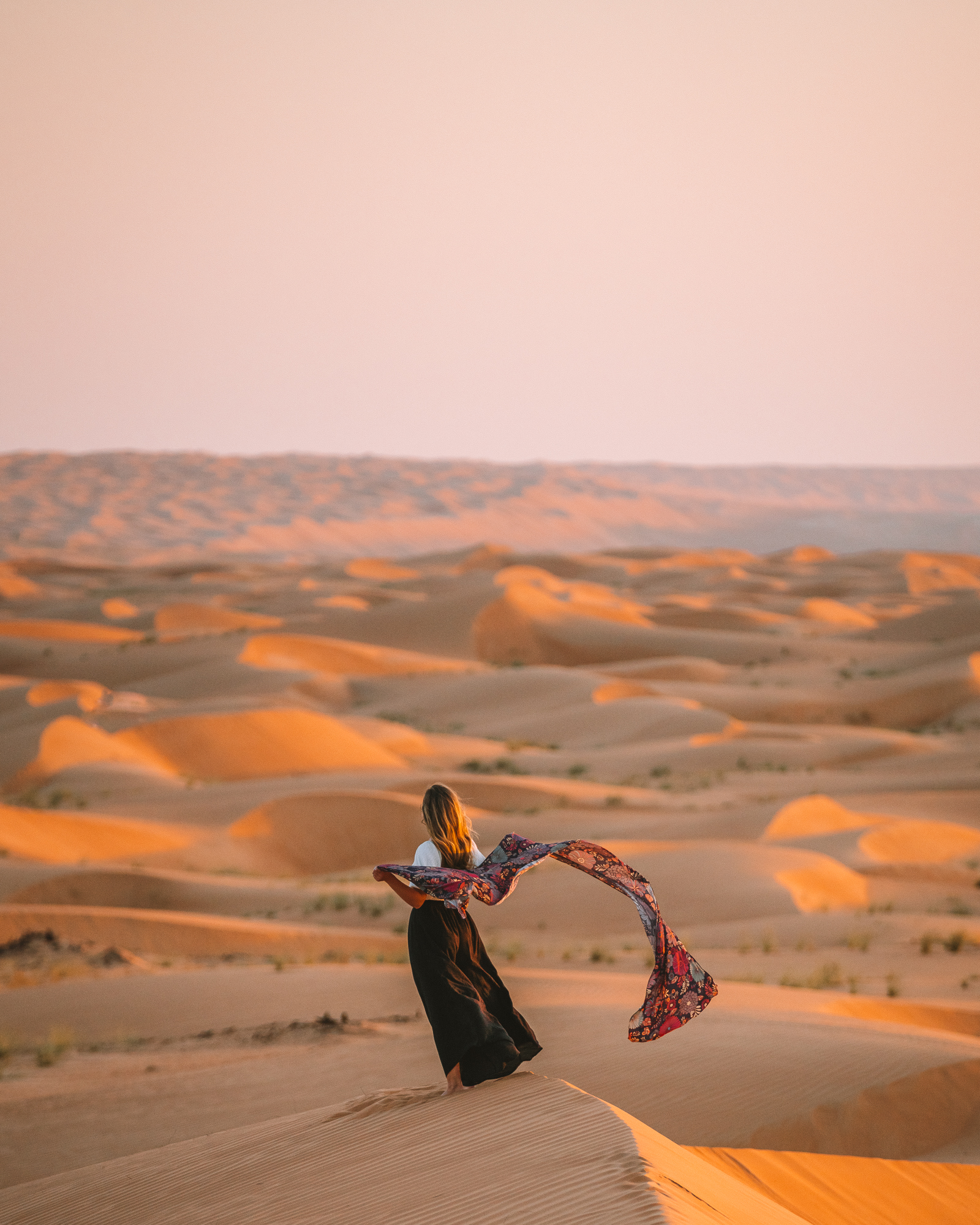 Michelle Halpern standing on the sand dunes of Wahiba Sands in Oman