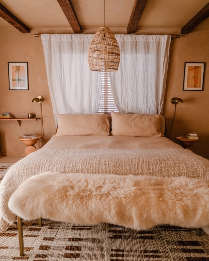 Bedroom interior at Hacienda Bedroom interior at Hacienda by the Joshua Tree House featuring warm tones and natural textures