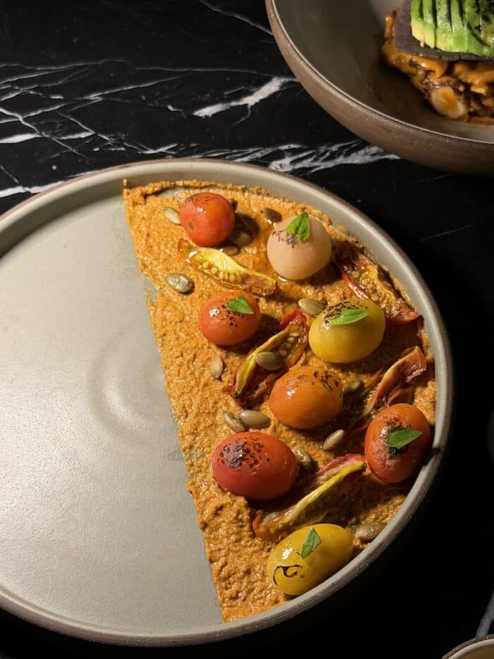 Close up of an appetizer featuring cherry tomatoes