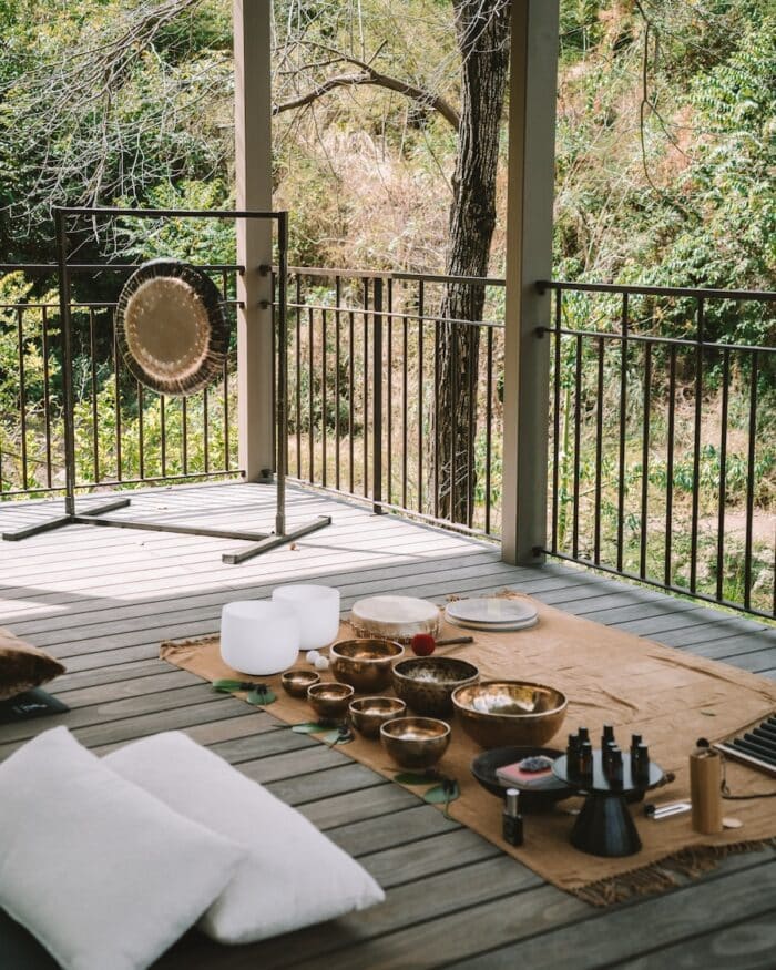 Sound bath setup on the yoga deck surrounded by jungle.