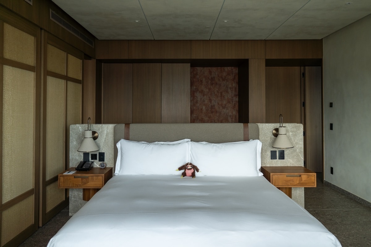 View inside one bedroom king suite at Waldorf Astoria Costa Rica - king bed with sloth stuffed animal.
