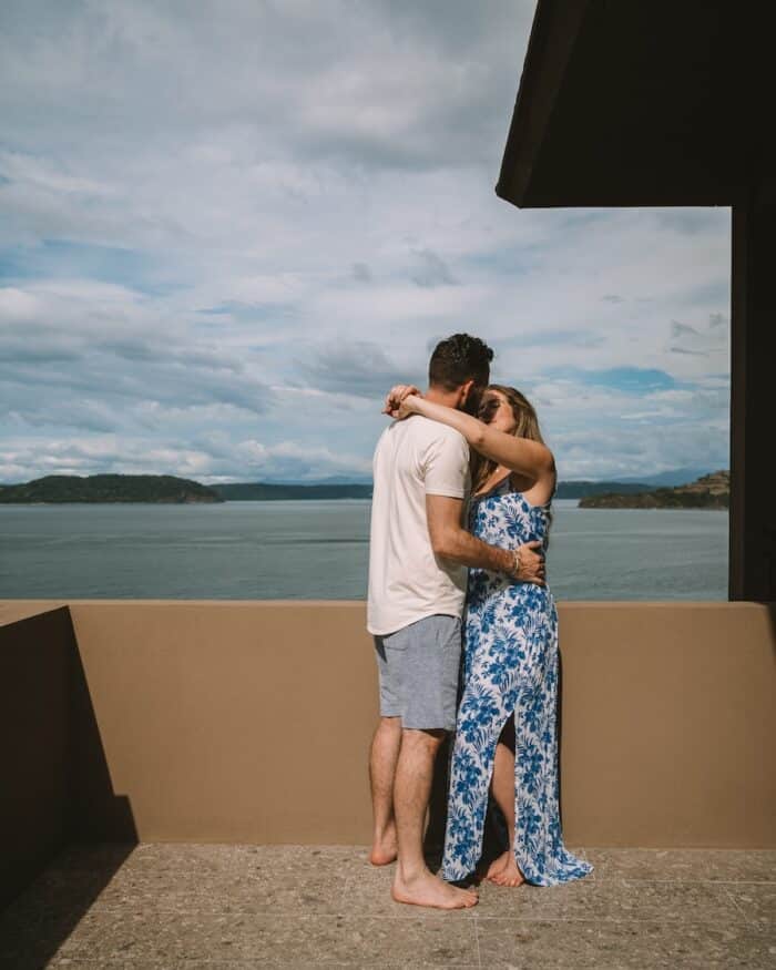 Michelle and husband kissing on balcony