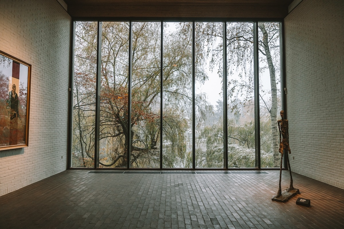Louisiana Museum View inside one of the larger gallery rooms at the Louisiana Museum in Denmark with floor to ceiling glass windows