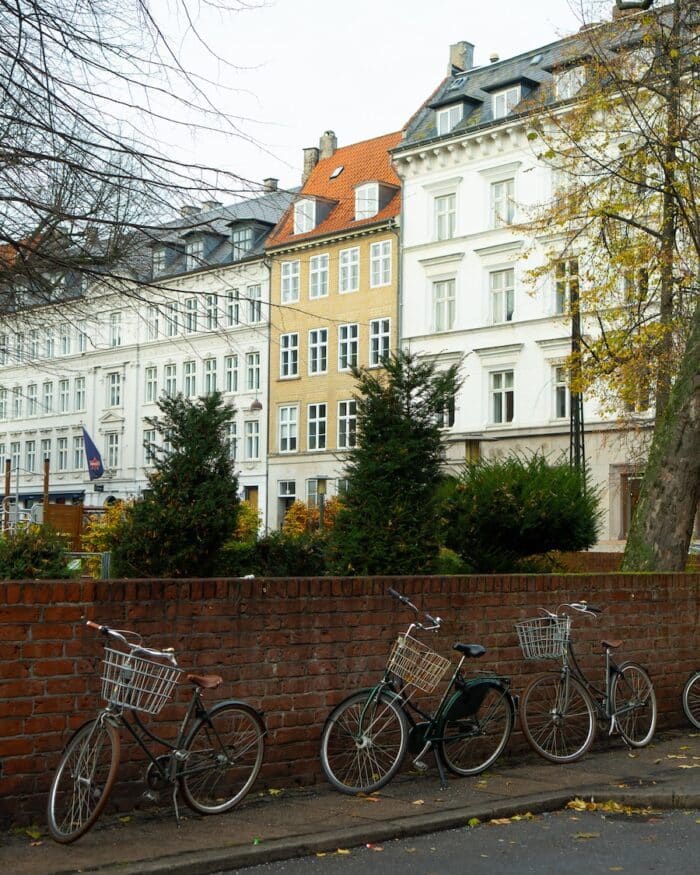 Bikes lined up along a wall Bikes lined up along a wall