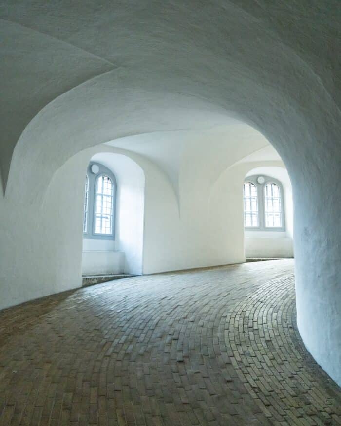Round Tower in Copenhagen Interior of the walkway up the Round Tower in Copenhagen with sloping white ceilings and stone