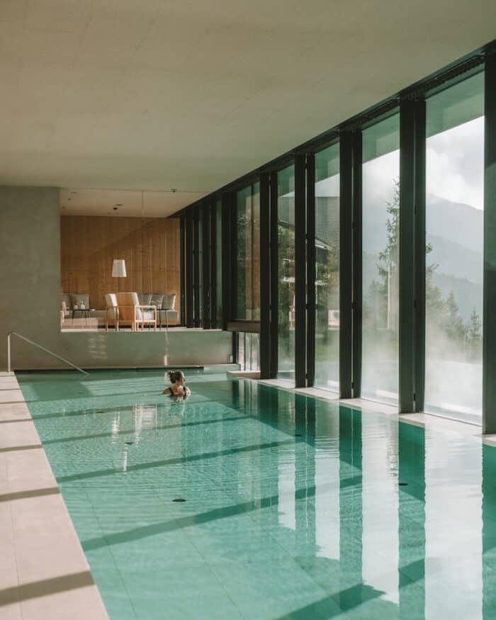 indoor pool Michelle Halpern swimming in turquoise indoor pool with the sun streaming inside