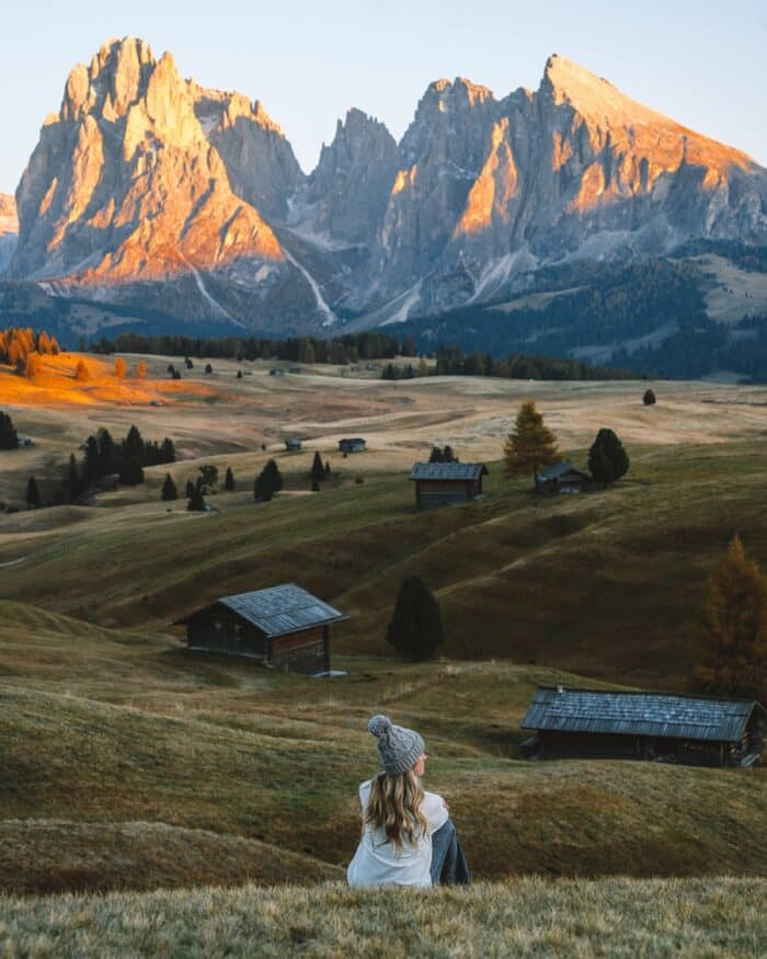 sunset over Alpe di Siusi Michelle Halpern sitting on the meadow watching the sunset over Alpe di Siusi