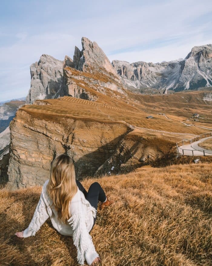 peaks at Seceda Michelle Halpern sitting on grass admiring the peaks at Seceda in the Dolomites