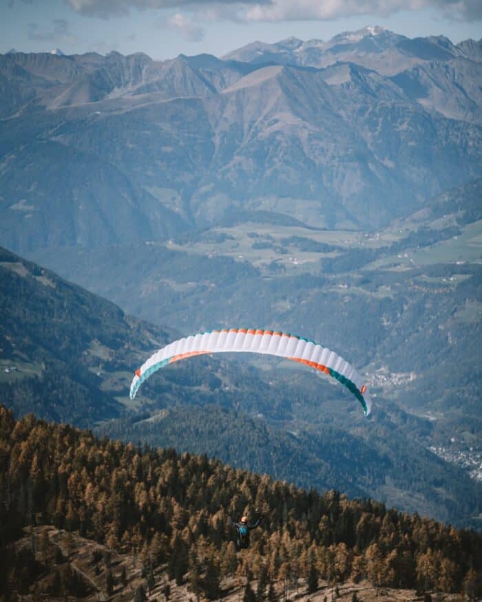 Paraglider Paraglider flying in air after launching off Kronplatz in Italy