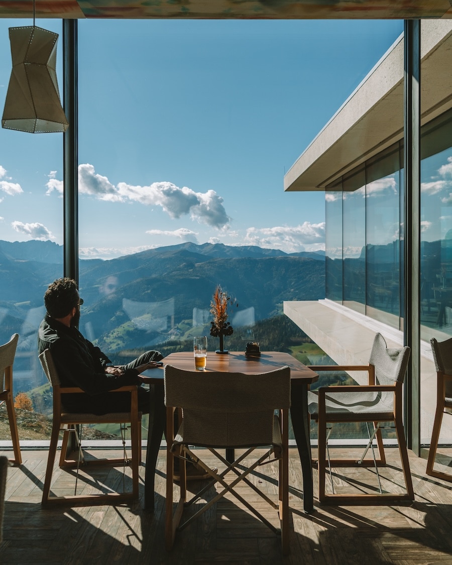 cafe at the Lumen museum JT sitting at a table at the cafe at the Lumen museum, watching the mountains in the distance