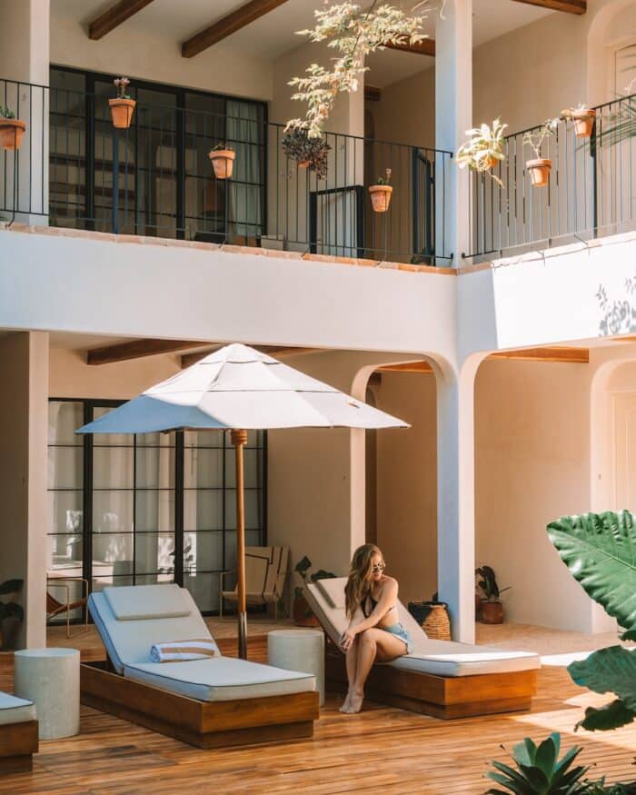 Sendero Hotel in Nosara Michelle Halpern sitting on sun lounger in the courtyard at Sendero Hotel in Nosara, Costa Rica