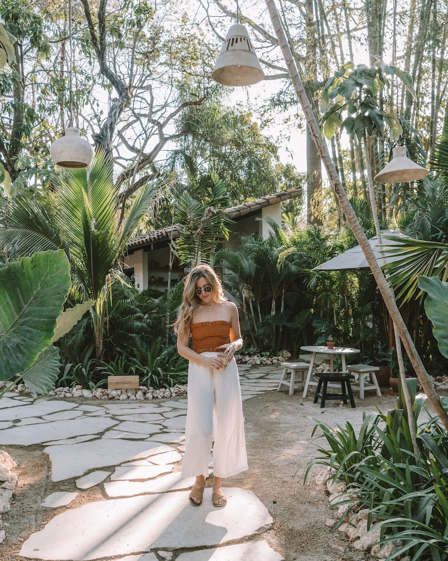jungle oasis Michelle Halpern standing in jungle oasis holding a coffee cup