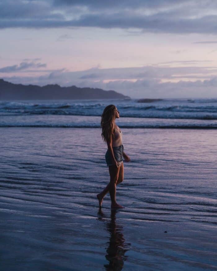 blue hour in Nosara Michelle Halpern wading through shallow water at blue hour in Nosara