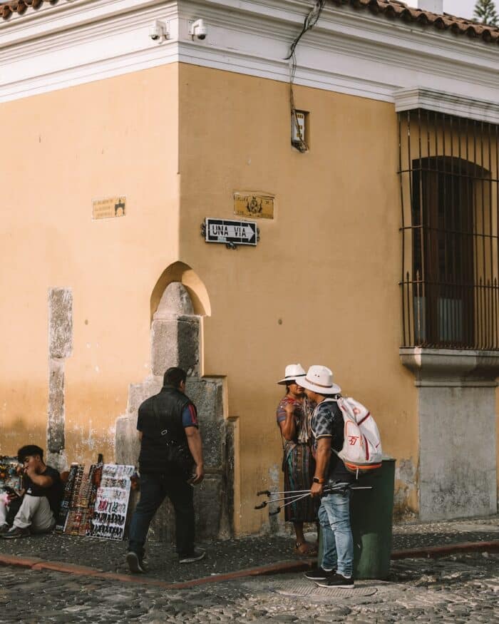 yellow building corner Locals on a yellow building corner in Antigua