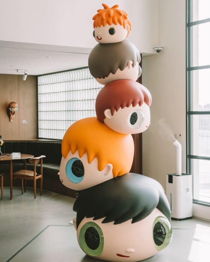 D Museum Seoul Sculpture of stacked cartoon heads inside the D Museum, Seoul