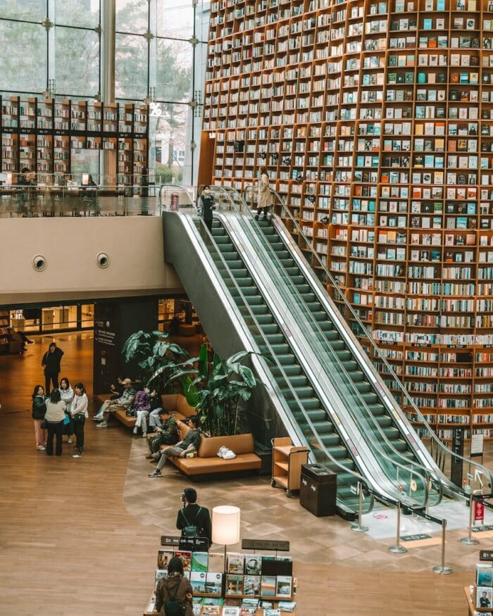 inside Starfield Library Interior view inside Starfield Library in Seoul with an escalator and floor to ceiling wall full of books