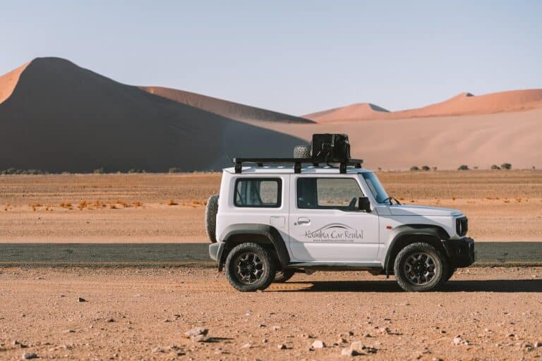 Namibia Car Rental vehicle parked on the side of the paved road in Sossusvlei Namibia