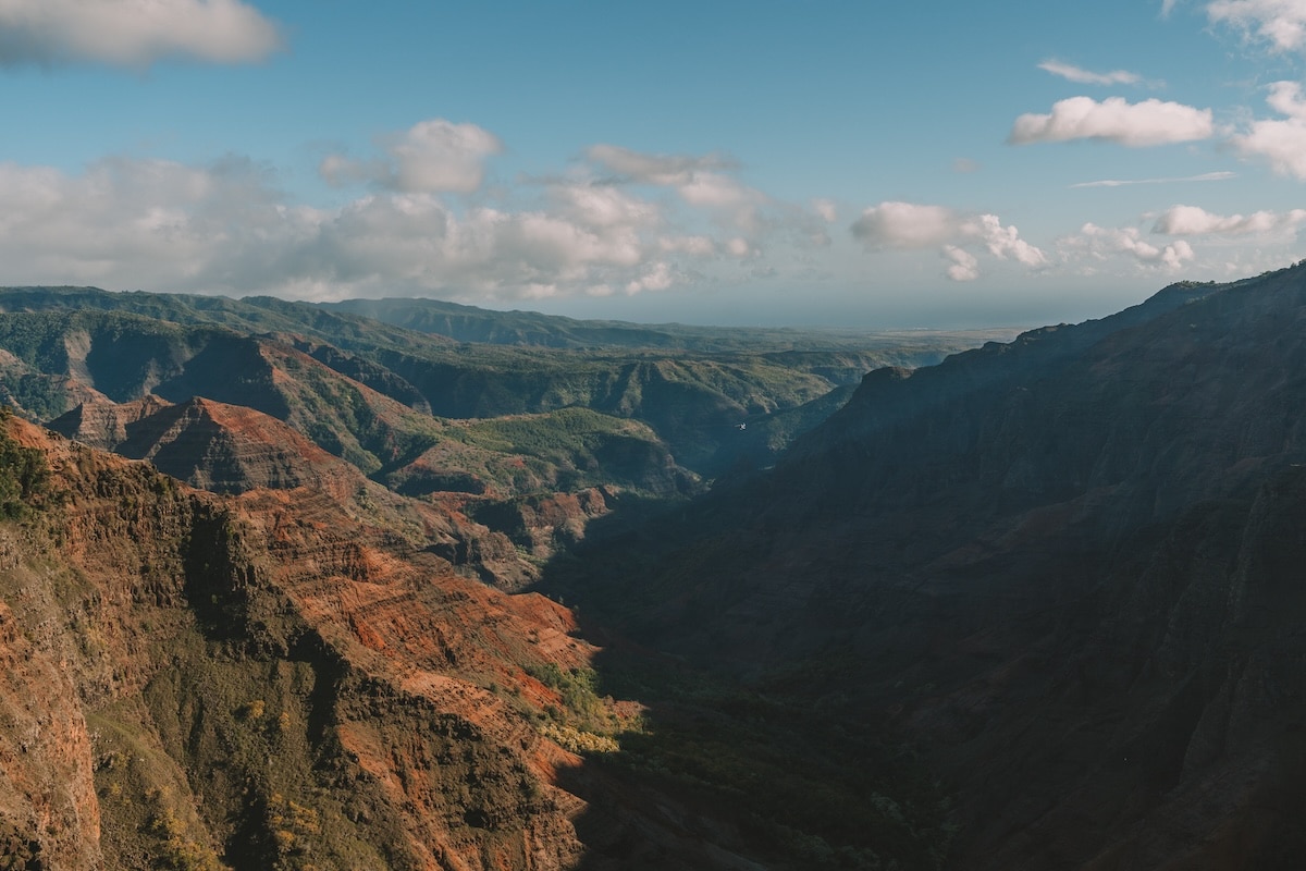 orange rock in Waimea Canyon Lush green crevices and orange rock in Waimea Canyon