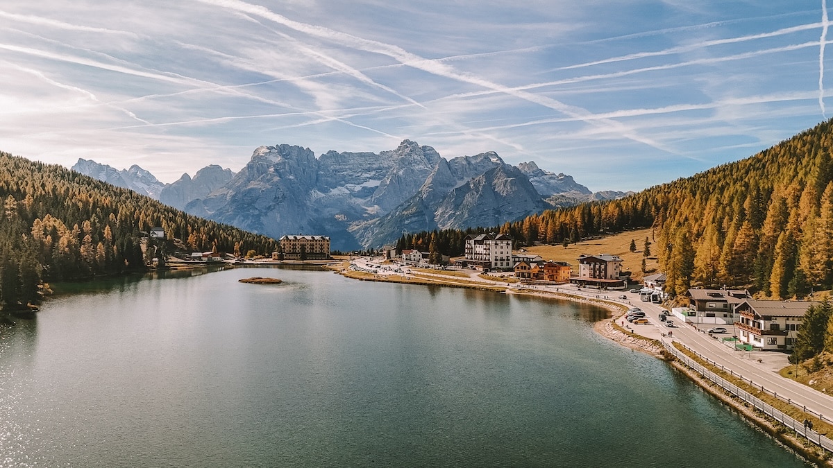 Drone shot of Lake Misurina Drone shot of Lake Misurina in fall with fall leaves peaking from the forest