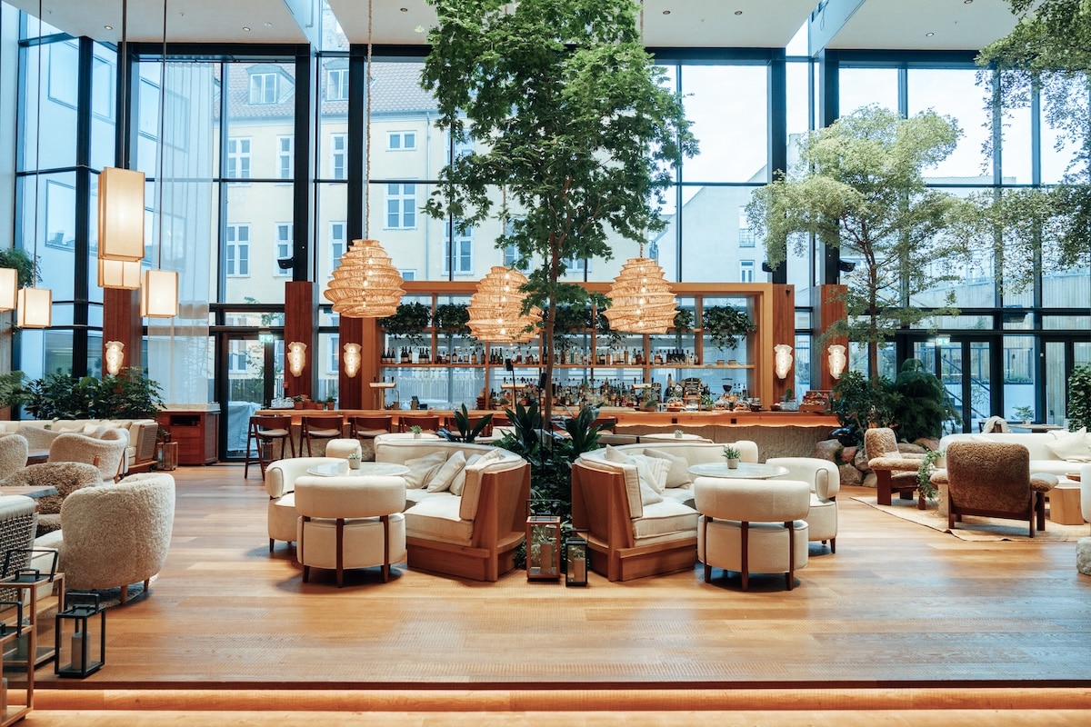 1 Hotel Copenhagen lobby Spacious light filled lobby at the 1 Hotel Copenhagen featuring neutral decor and lush green plants