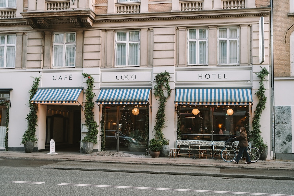 Hotel Coco Street facing facade of Hotel Coco featuring striped blue and white awning