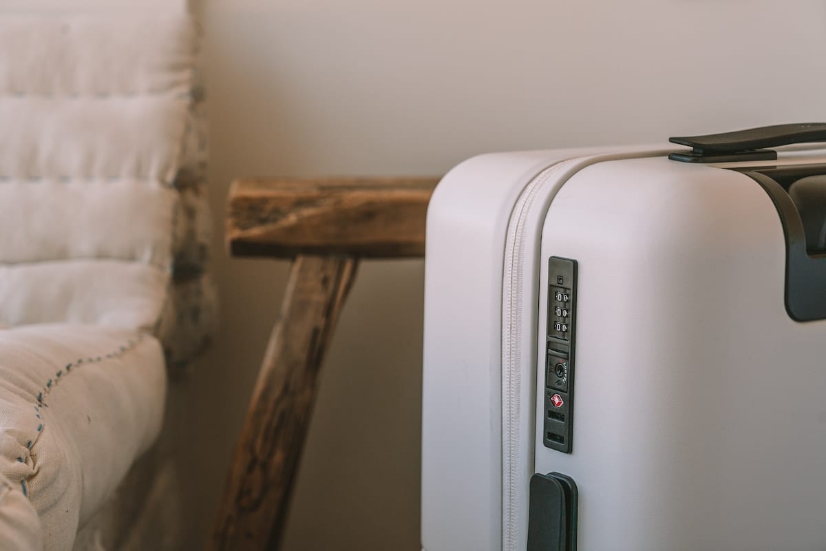 Packing List for International Travel Shot of the corner of a white suitcase | Packing List for International Travel