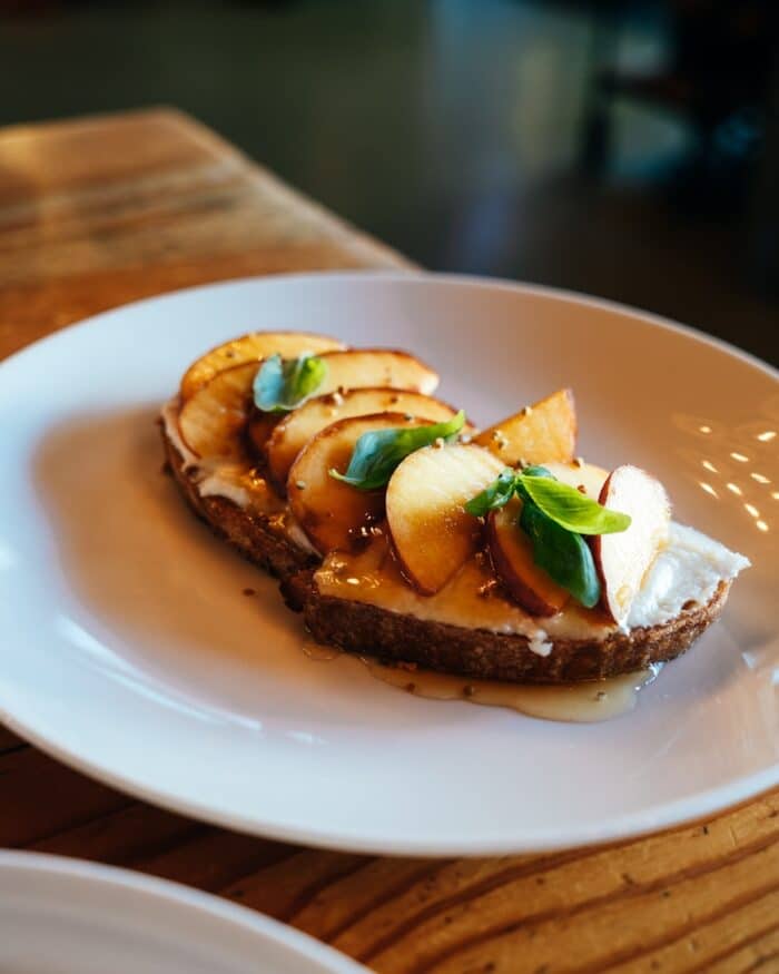 peach and ricotta toast Close up shot of peach and ricotta toast from Helena Avenue Bakery