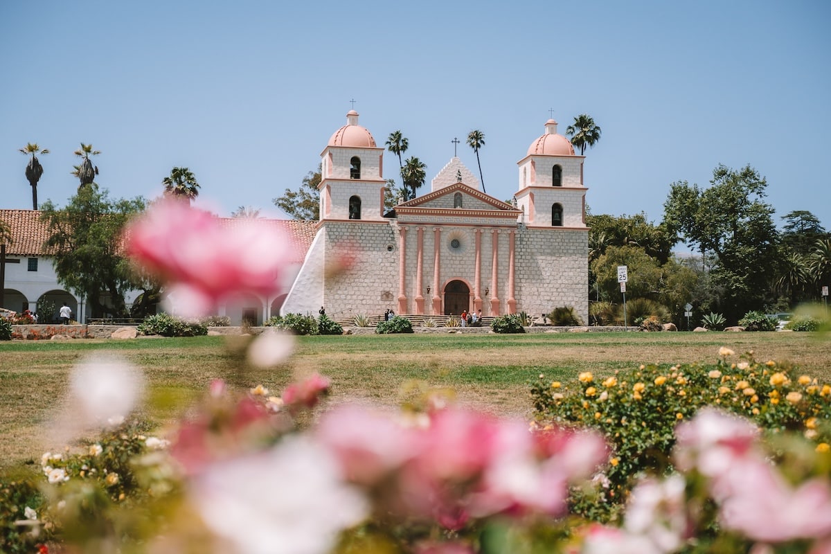 Old Mission in Santa Barbara Old Mission in Santa Barbara with pink roses in the foreground