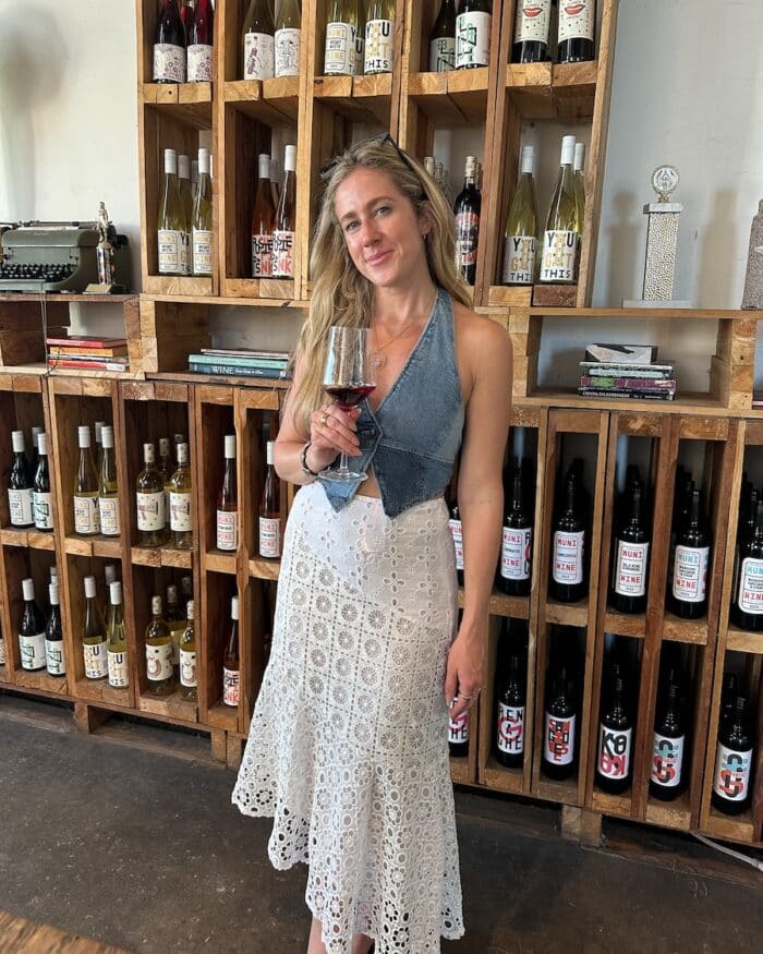 wine at Muni Wines Michelle Halpern holding a glass of wine at Muni Wines
