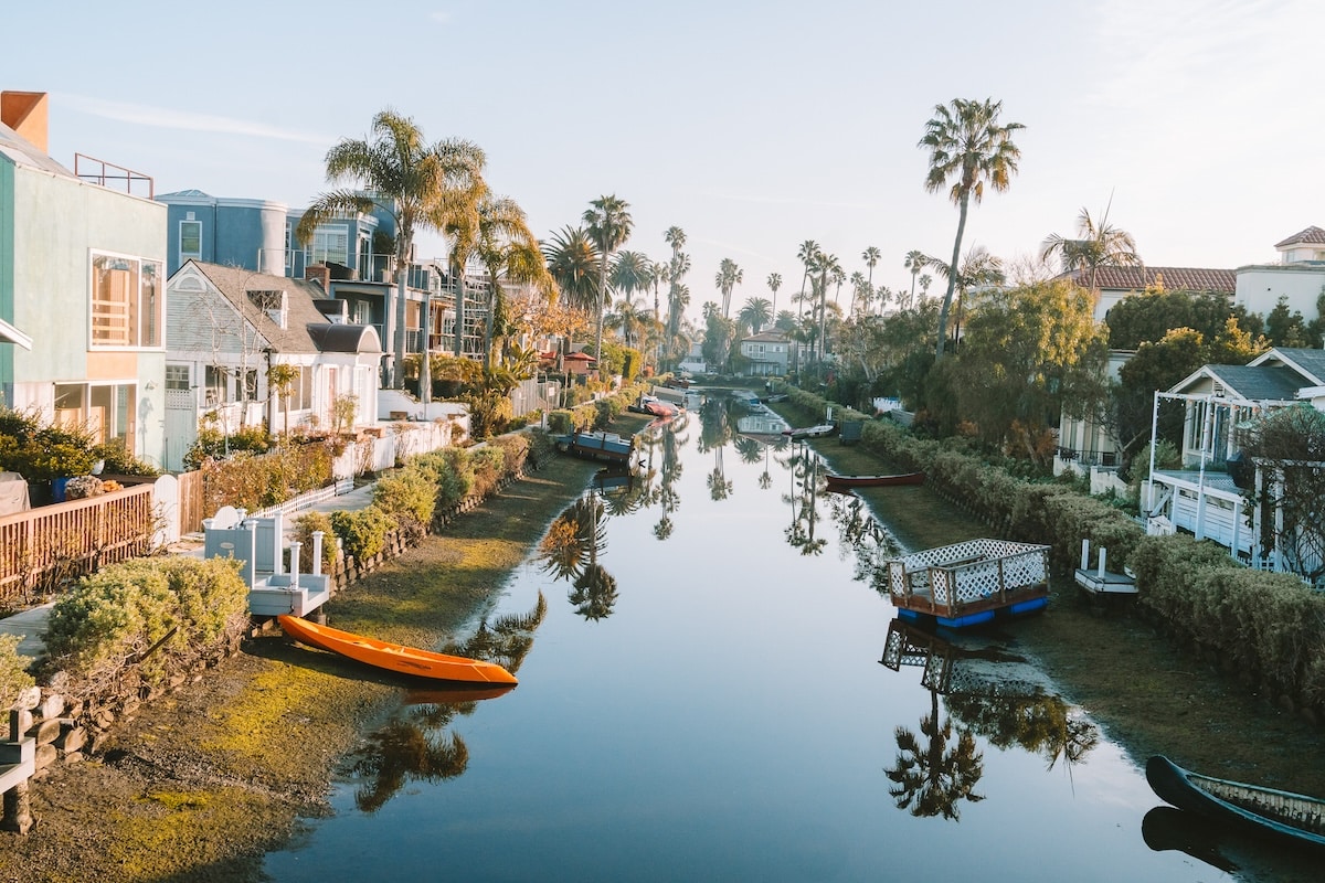 Venice Canals surrounded by houses View from up on a walk bridge looking down into the Venice Canals surrounded by houses on either side