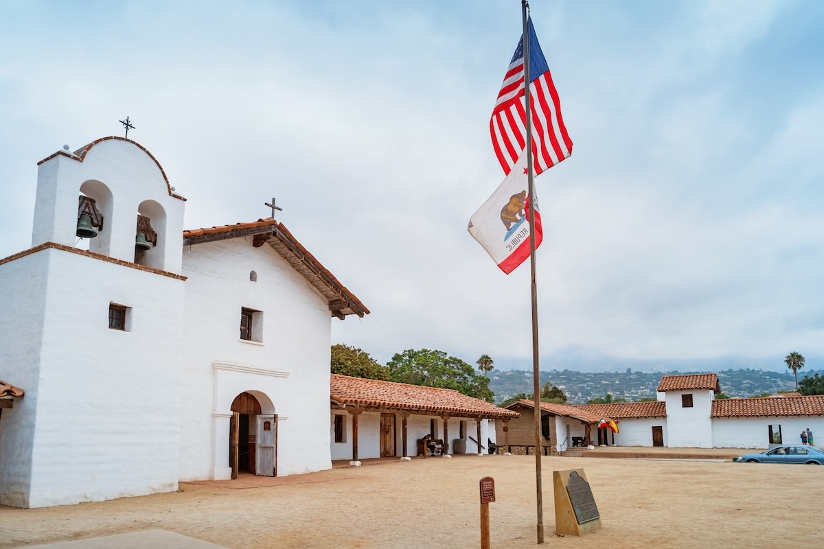 El Presidio de Santa Barbara El Presidio de Santa Barbara State Historic Park with California and USA flags in foreground