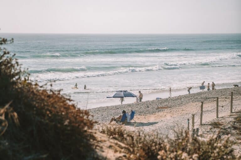 Couple sitting under an umbrella on the beach