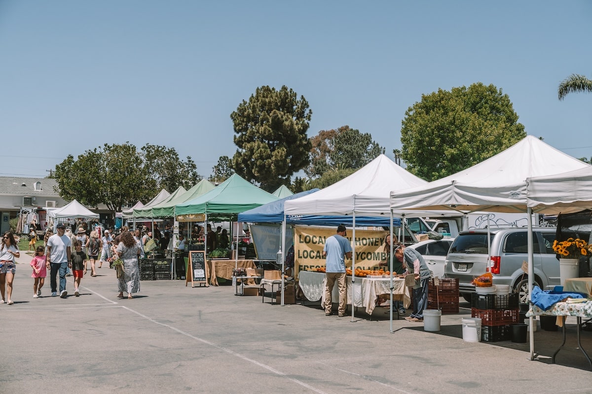 Row of pop up tents Row of pop up tents with vendors selling produce at Leucadia Farmer's Market