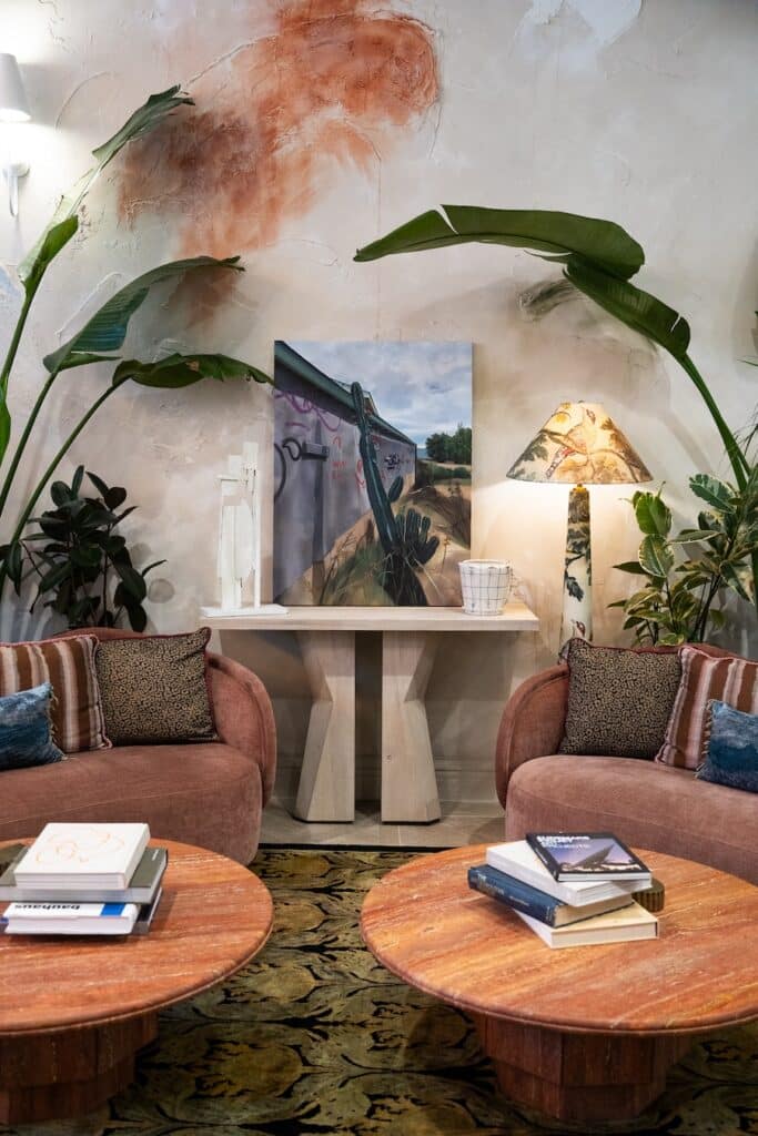 lush green plants and artwork Cozy couches framed by lush green plants and artwork on the walls