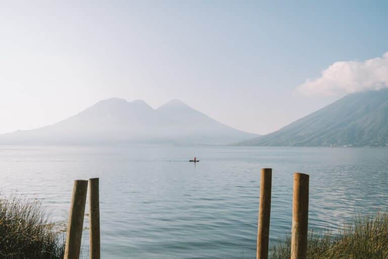 Calm moment on Lake Atitlan where one lone boater is rowing through the lake