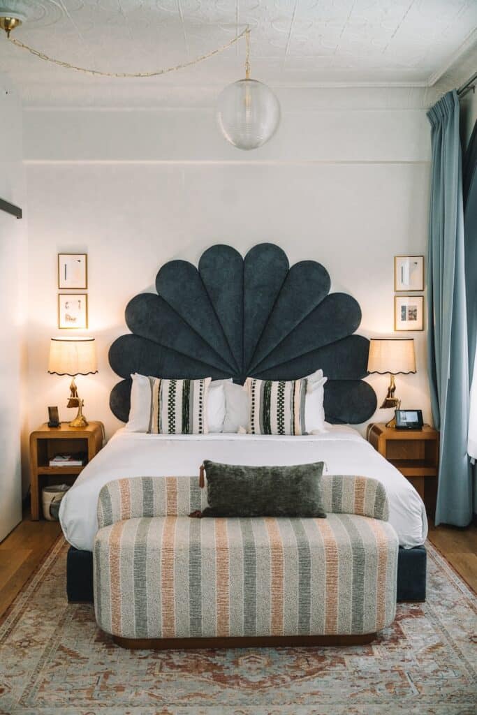 scalloped bedframe Bed featuring a scalloped bedframe in the guest room at Granger Hotel