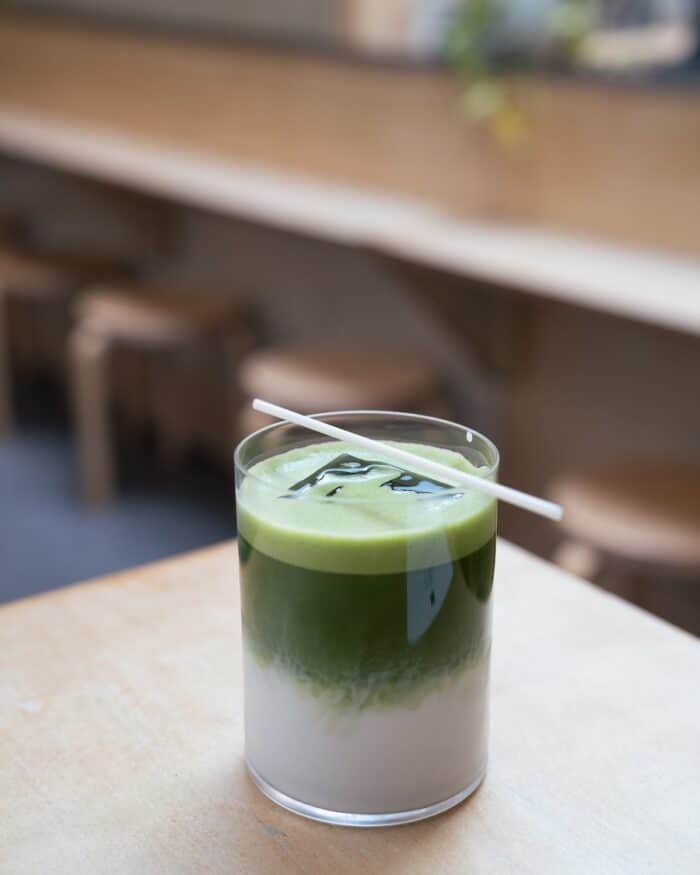 Iced matcha latte Iced matcha latte with a straw balancing on top