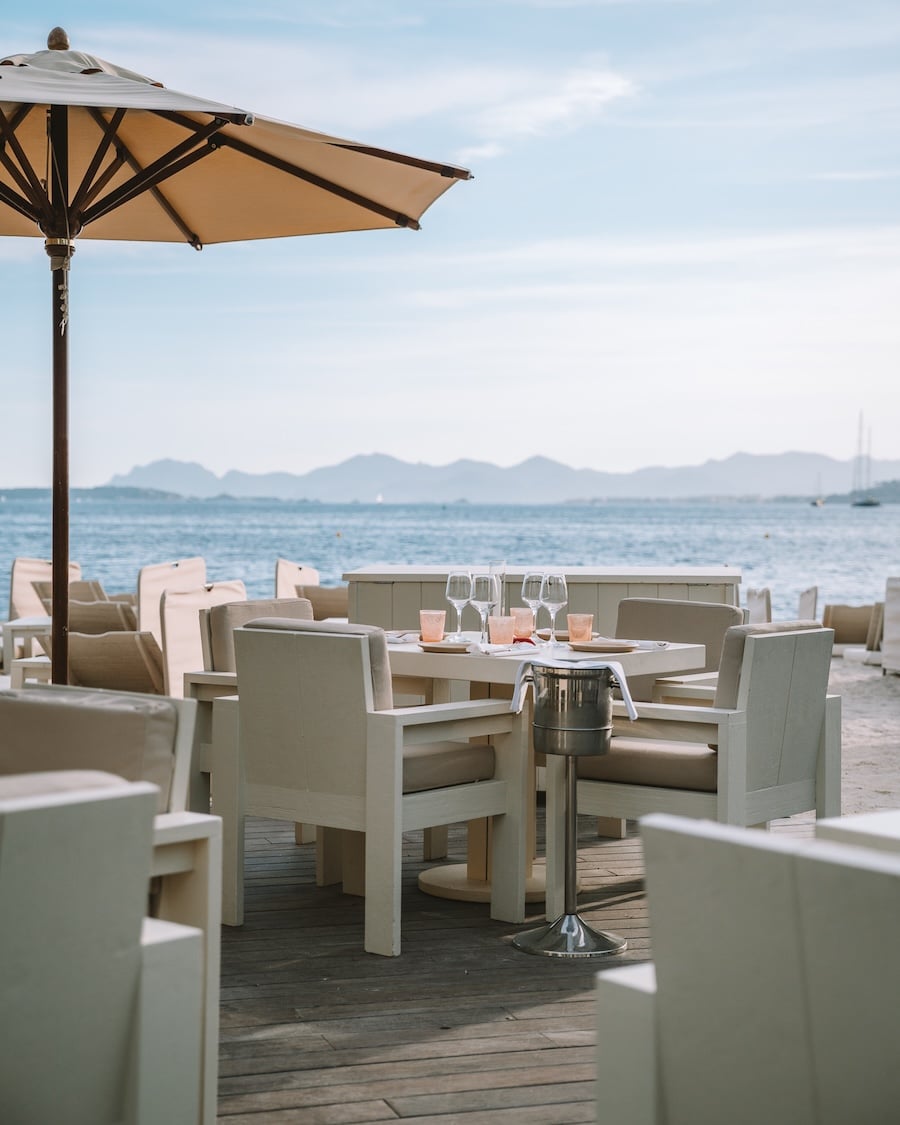 dinner in Antibes Tables set up for dinner in Antibes with a sea views and sailboats in the distance