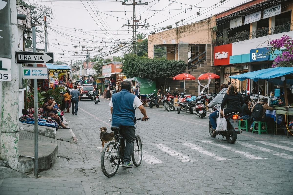 Busy street in Panajachel Busy street in Panajachel with vendors and locals on bikes and scooters