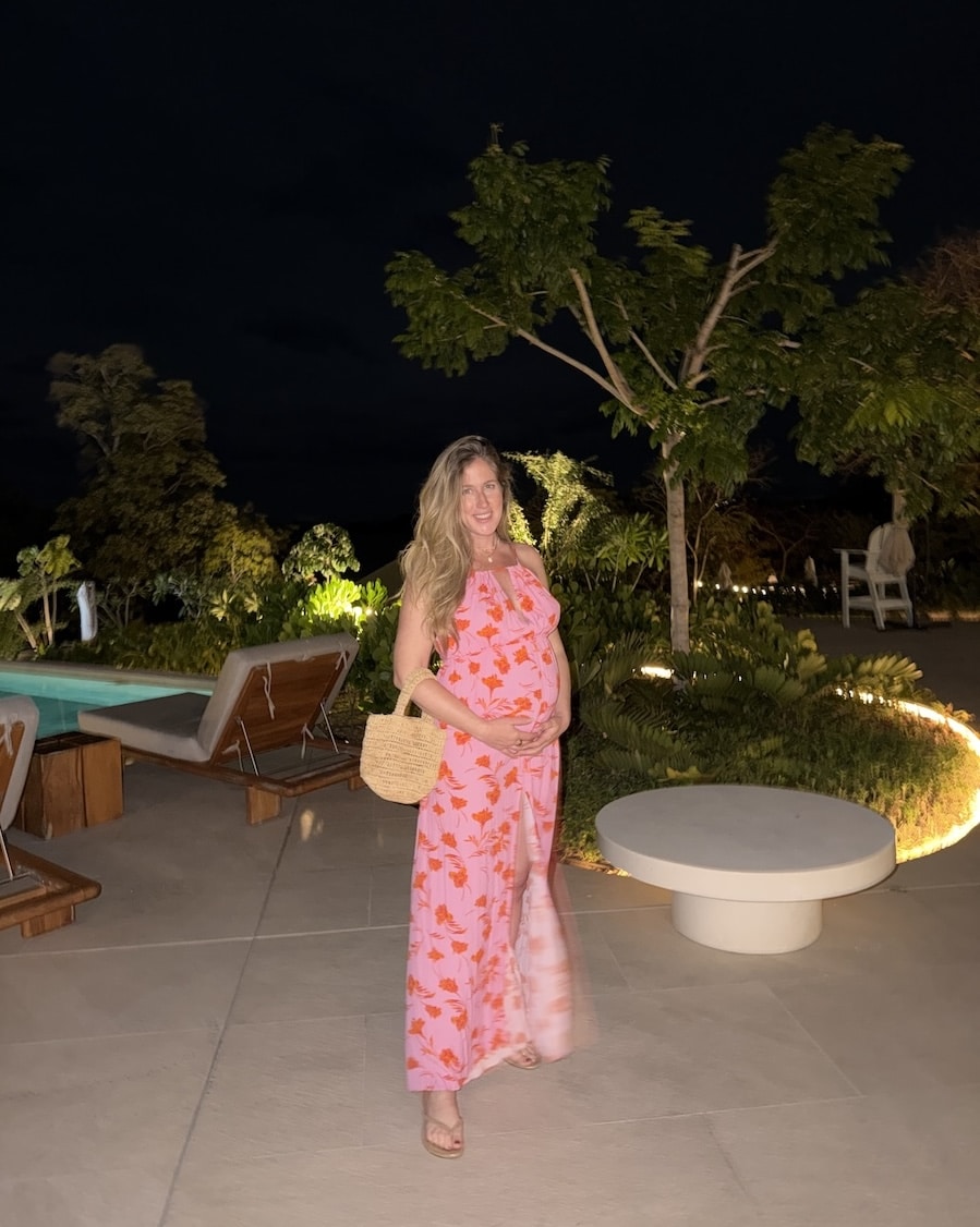 pink maxi dress Michelle Halpern in a pink maxi dress holding a raffia bag | What To Pack For A Beach Vacation