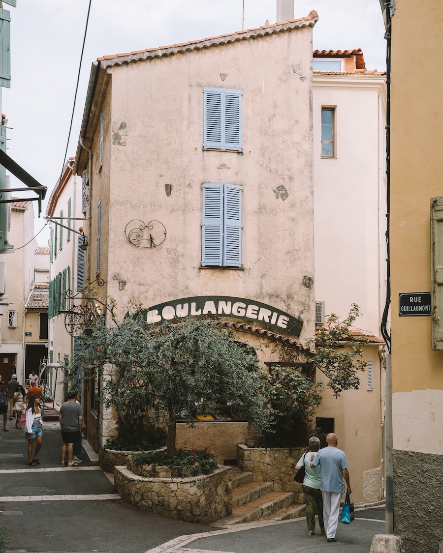 Boulangerie Building with pastel shutters with the word "Boulangerie" written across it