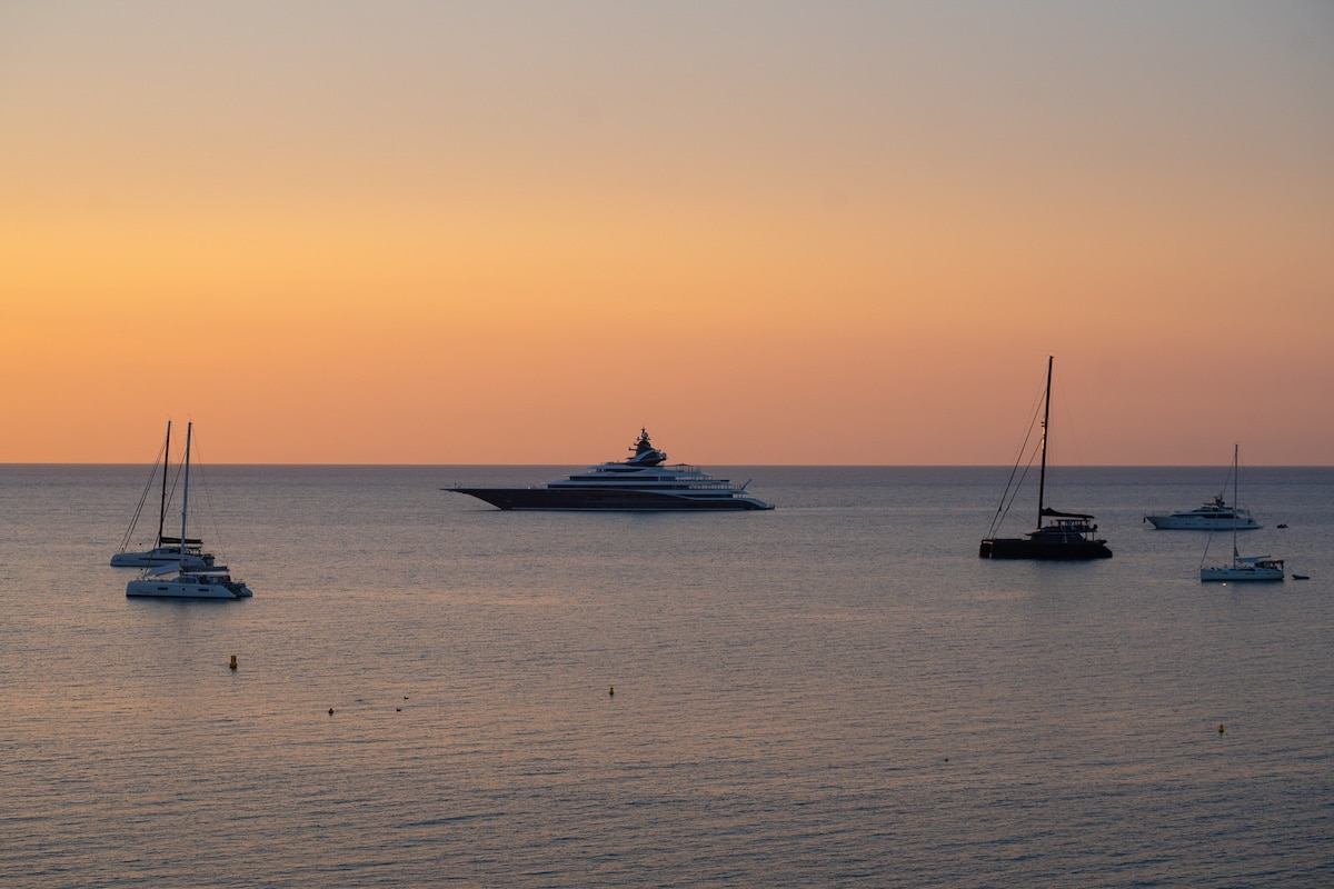 Sunset and yachts Sunset over the water with luxurious yachts docked