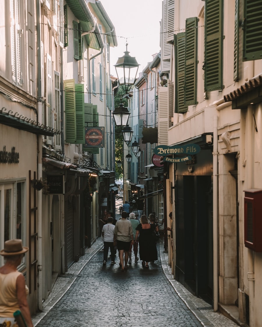 Old Town Antibes Charming pedestrian-only street in Old Town Antibes filled with buildings with green shutters