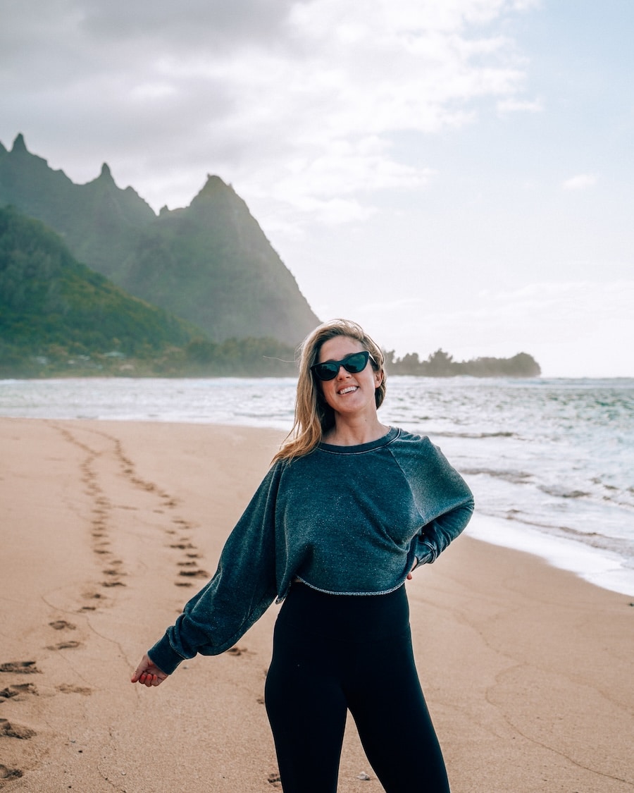 loose sweater on and leggings Michelle Halpern in Kauai with a loose sweater on and leggings at Tunnels Beach | What To Pack For A Beach Vacation