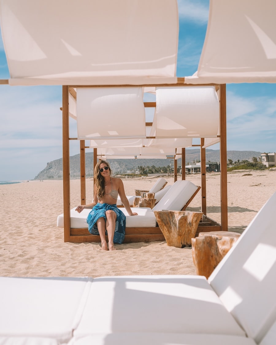 beach cabana Michelle Halpern sitting on the side of a beach cabana wearing a sarong and bikini