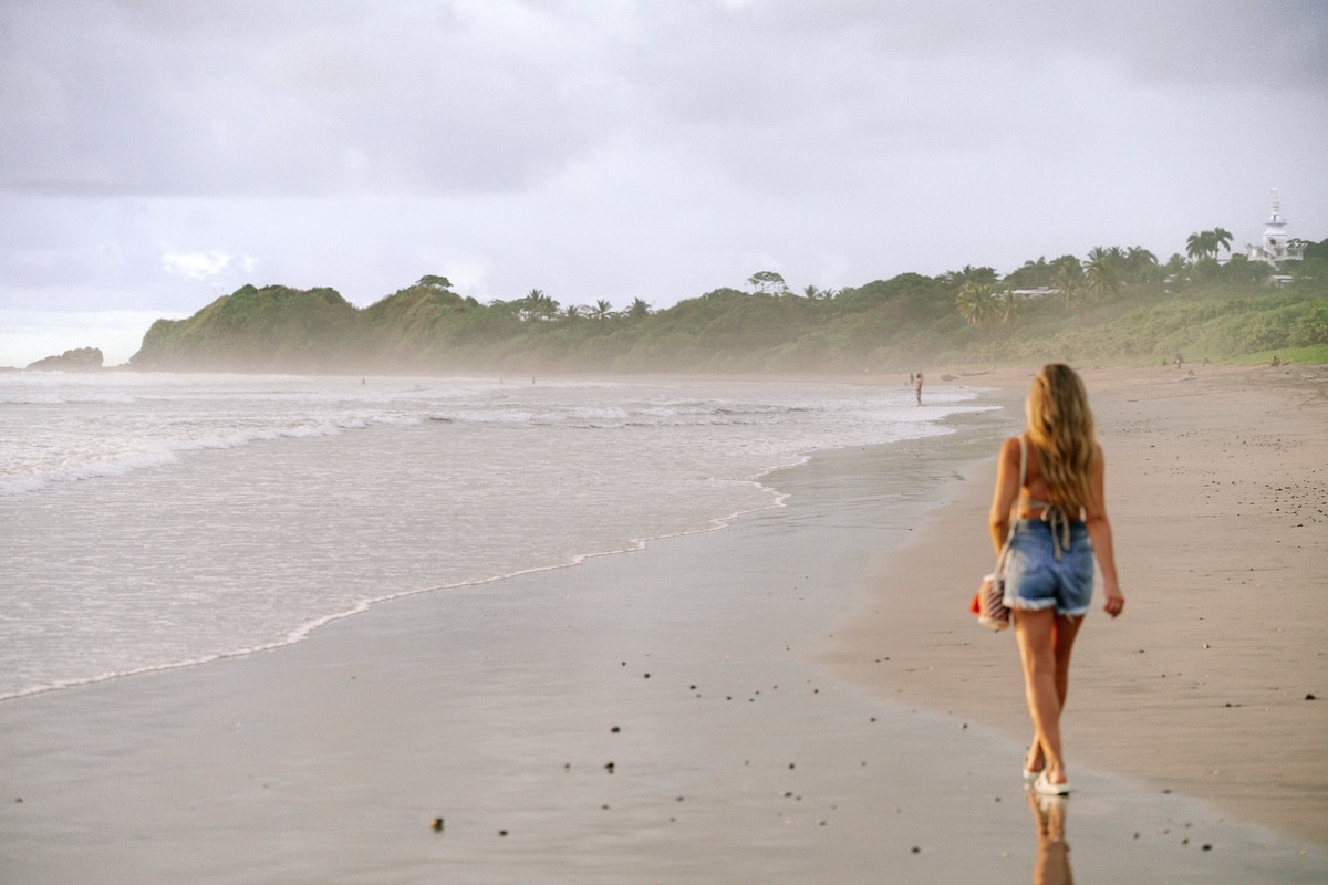 misty beach in jean shorts Michelle Halpern walking along a misty beach in jean shorts