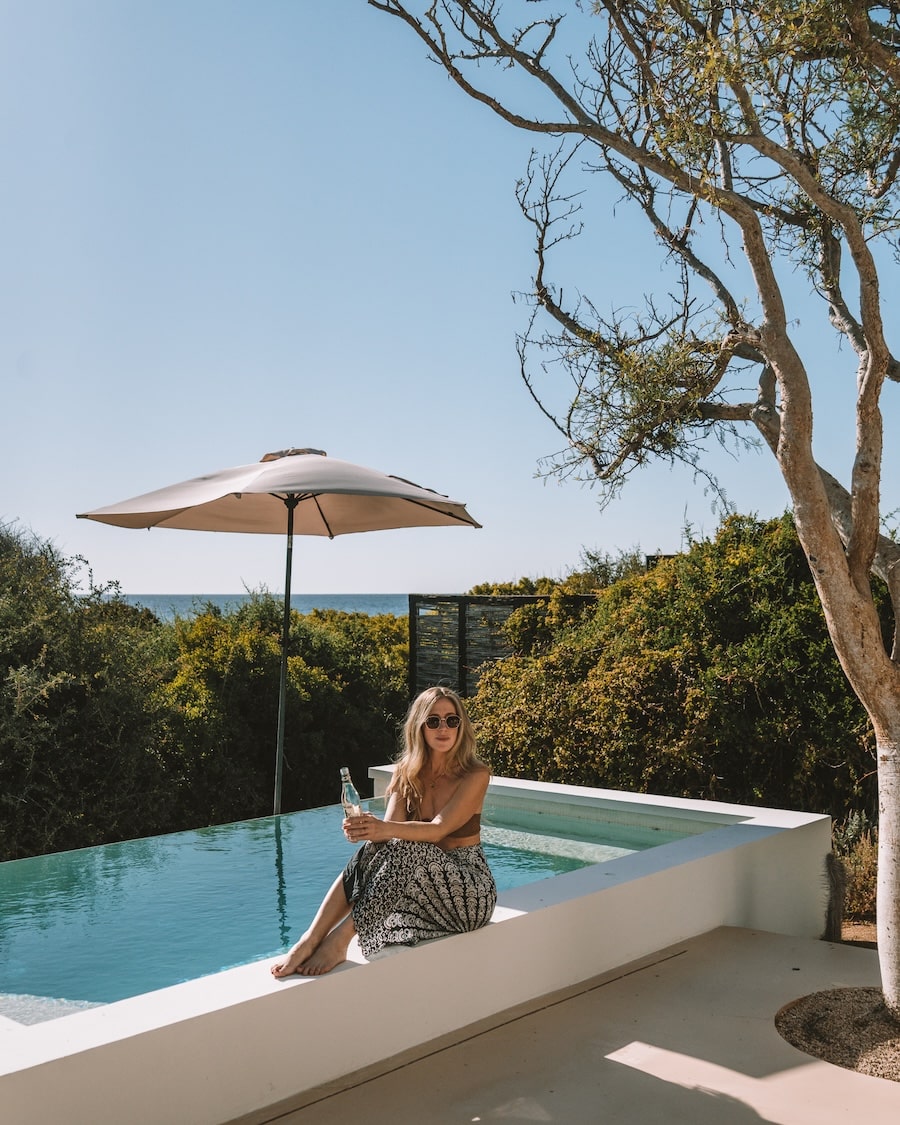 Michelle edge of a pool Michelle Halpern wearing a sarong and bikini top sitting on the edge of a pool