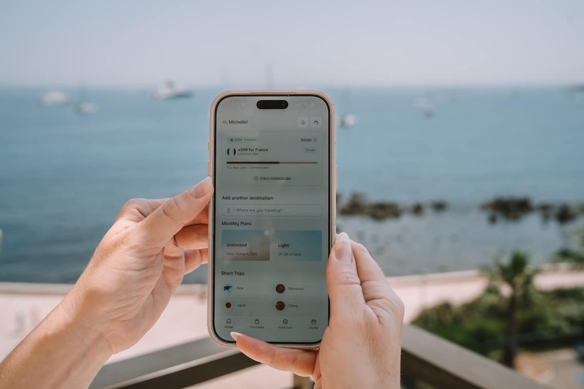 France eSIM Hands holding up a phone that shows it's been installed with a France eSIM