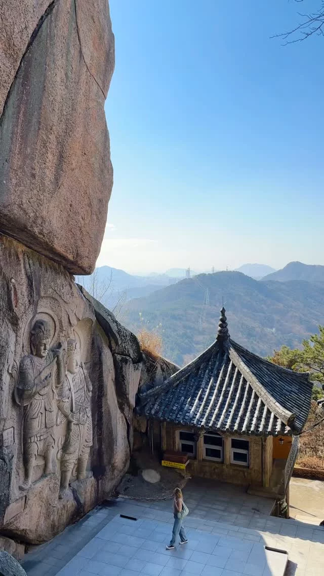 Save this hidden temple in Busan, South Korea for your next trip 🇰🇷 Tips for visiting below! 

📍Seokbulsa Temple 

When I was putting together this Busan itinerary, I kept seeing the same temples over and over but very few people were talking about this one! 

Yes, it’s a little off-the-beaten path but it’s one of the most unique temples I’ve ever visited and it was so different than anything else we saw in South Korea with its stunning cave features and cliff carvings. Plus on a clear day you can get skyline views of Busan from right inside the temple. 

If you’re looking for the most peaceful temple in Busan, this is it 🤩

ABOUT SEOKBULSA TEMPLE: 
• This is a Buddhist temple featuring rock carvings, some about 40 feet high! 
• Visitors can explore 29 total Buddhist carvings here 
• The temple was built by a Buddhist monk in the 1930s 
• Make sure to walk up the staircase at the back to get an incredible view of the Busan skyline on a clear day 🙌🏻
• The name translates to “stone Buddha temple” 

HOW TO VISIT SEOKBULSA: 
• The best and fastest way is by car (we booked a private tour guide for the day and requested to come here, which we discovered is rare for tourists). • If taking the subway, the closest stop is the Mandeok station but it’s a trek from there (about an hour). 
• I haven’t done this route, but I’ve heard it’s also possible to get there via Oncheonjang station then taking the Geumgang cable car up Geumjeong mountain and then hiking the final stretch. 
• Once you arrive at the parking lot, it’s about a 25 minute walk/hike uphill to reach the temple. 

WHEN TO VISIT: 
• I think morning is best for nice light, but no matter the time of day it won’t be too crowded as it’s harder to get to. We saw maybe 3 other people the whole hour we were there. 

Have you heard of this gorgeous temple in Busan? 😍